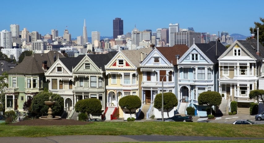 View of row houses in San Francisco with city in the background