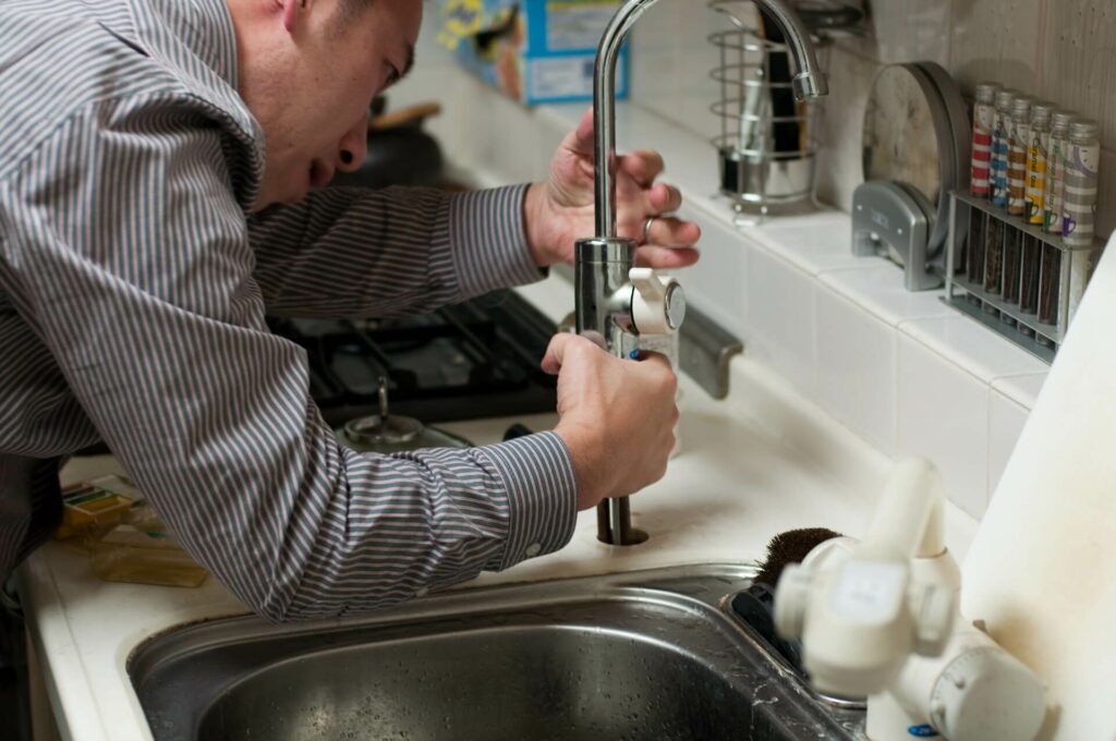 Man fixing sink faucet